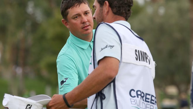 Jason Dufner shakes hands with Webb Simpson's caddie after the final hoel at La Quinta Country Club during the third round of the CareerBuilder Challenge, January 23, 2016.
