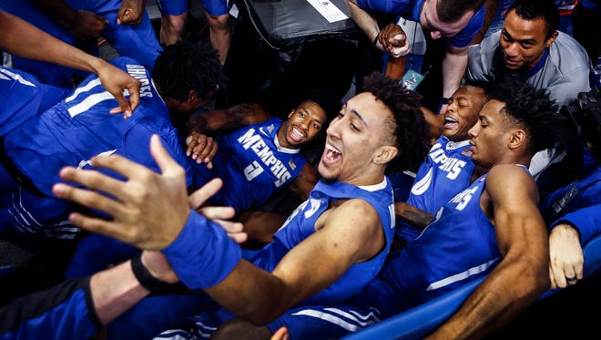 Memphis guard Kareem Brewton Jr. (middle) is clobbered by his teammates after sinking a game-winning three pointer to defeat Tulsa 67-64 duringtheir AAC second round tournament game in Orlando, Fl., Friday, March 9, 2018.
