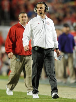 Urban Meyer (right) walks the sidelines during the