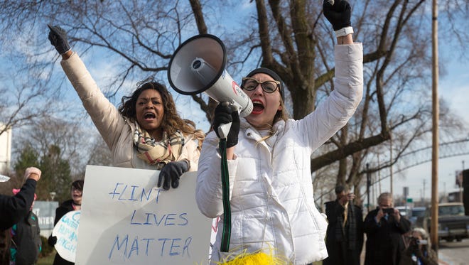 The first lady of Prince of Peace Church April Cook-Hawkins, left, and Breanna Butler, 27, of New York, and head of state and global organizer for Women's March, cheer as the crowd gathers during the Selma Solidarity March on Sunday, March 5, 2017 in Flint.