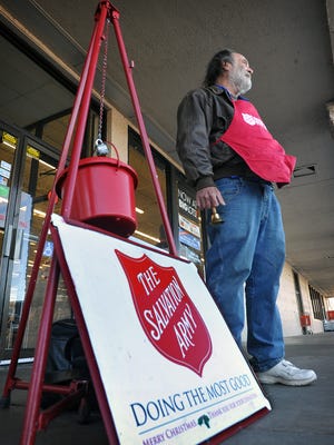 Charlie English, a bell ringer for the Salvation Army, mans the red kettle donation station in front of the Big Lots store Friday morning. Friday was the first day of the holiday season for the Salvation Army to collect donations.