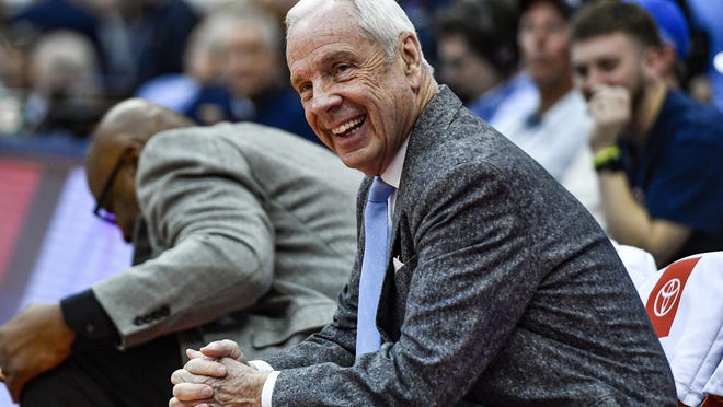 Coach Roy Williams enjoys a moment on the bench before North Carolina's eventual victory at Syracuse in February.