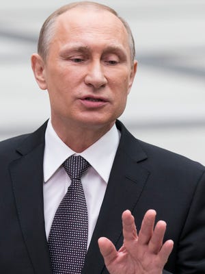 Russian President Vladimir Putin gestures while speaking to the media after a nationally televised question-and-answer session in Moscow in Moscow, Russia, Thursday, April 16, 2015.