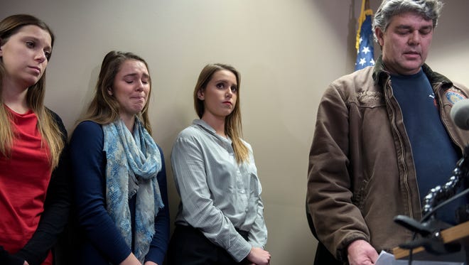 Randall Margraves, right, gives a statement as his daughters, from left, Lauren, Madison and Morgan look on during a press conference on Friday, Feb. 2, 2018, at the Grewal Law office in Okemos.