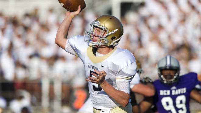 Cathedral High School junior Max Bortenschlager (5)  fires a pass off to a receiver during the first half of action at Ben Davis High School, Friday, August 22, 2014. Ben Davis High School hosted Cathedral High School in varsity football action.
