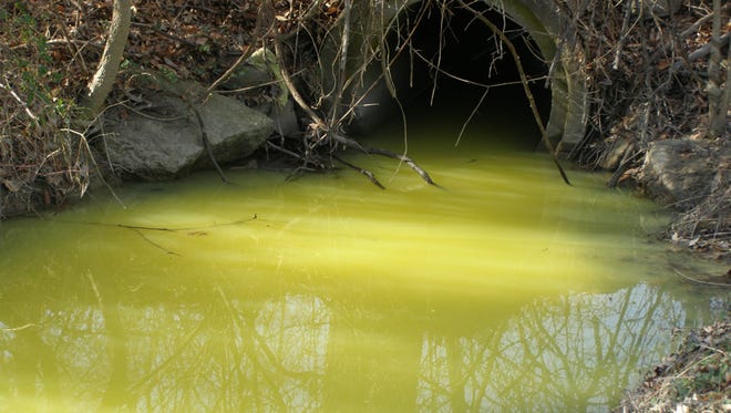A paint spill discolored water in a creek near Riverside Gardens in western Louisville. March 8, 2017