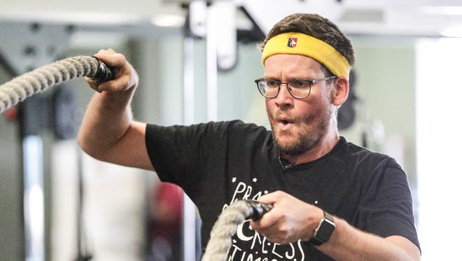 Indianapolis author John Green works out with battle ropes when making an episode of "100 Days" at So.Be.Fit.