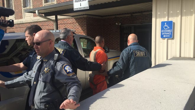 Norris Greenhouse Jr. is led into the Avoyelles Parish Courthouse on Tuesday. In a hearing in which 12th Judicial District Court Judge William Bennett ordered a bond for Greenhouse Jr. to be accepted, he also modified a gag order in the case.
