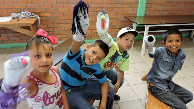 Health promoters in Palomas, Chih., Mexico, supported by Deming-based nonprofit Border Partners, are sponsoring a summer school for elementary school children. On Friday, the students presented a puppet show using their own hand-made puppets. Palomas school children display their hand-made puppets prior to Friday's show.