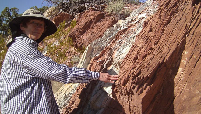 Hiking buddy Carolyn marvels at the fine vertical layers of siltstone and sandstone in Abo and Yeso formations at Stop No. 3.