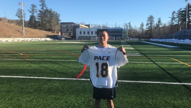 Pace lacrosse senior and Brick Memorial alum Ryan Calmon holds up No. 18, a special jersey for the Setters.