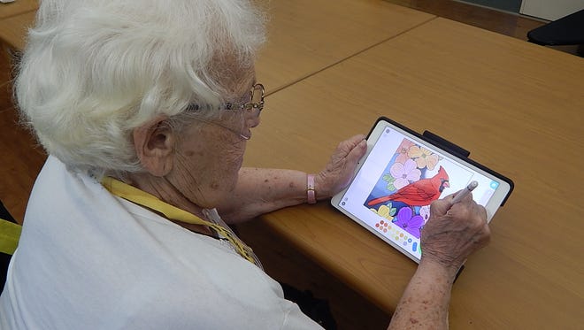 RCH resident and “Creations with Kayla” crafter Mary P. uses the IPad to create a colorful picture.