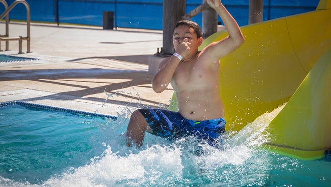 10-year-old Spencer Hart keeps cool in the hot sun by splashing into the water at Laabs Pool, June 15, 2016. Hart was one of about 60 children swimming at the pool as part of the City of Las Cruces’ Parks and Recreation Department Summer Recreation Program.