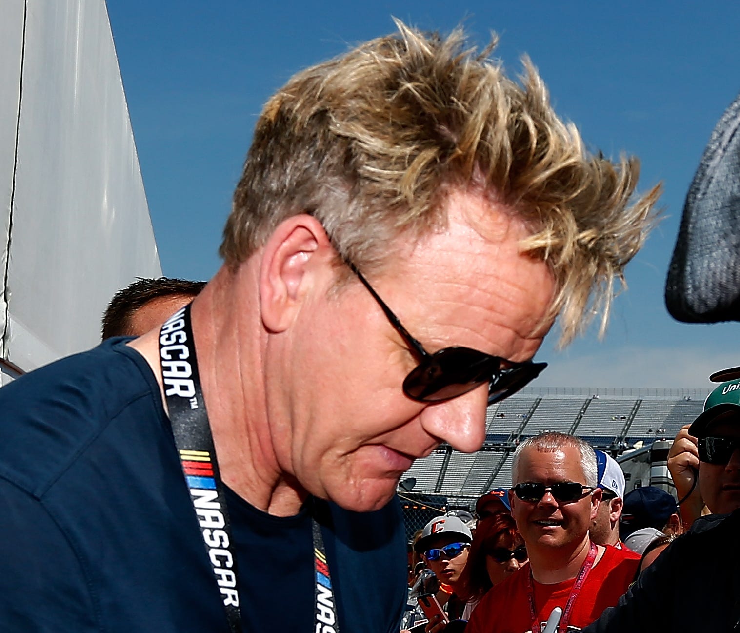 British celebrity chef, restaurateur, and TV personality Gordon Ramsay signs autographs before the NASCAR Cup race at Dover International Speedway.