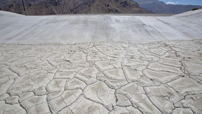 The cracked dry surface of Percolation Pond 5 awaits water at Windy Point on July 10, 2015.  The percolation ponds are used to refill the aquifer beneath the Coachella Valley with Colorado River water.