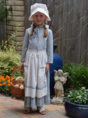 Lola Zvolanek models the prize winning "Little House on Prairie" costume which she wore in Children's Art & Literacy Festival parade.