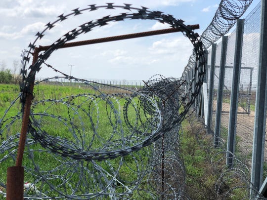 Barbed wire is seen near the end of border fence in