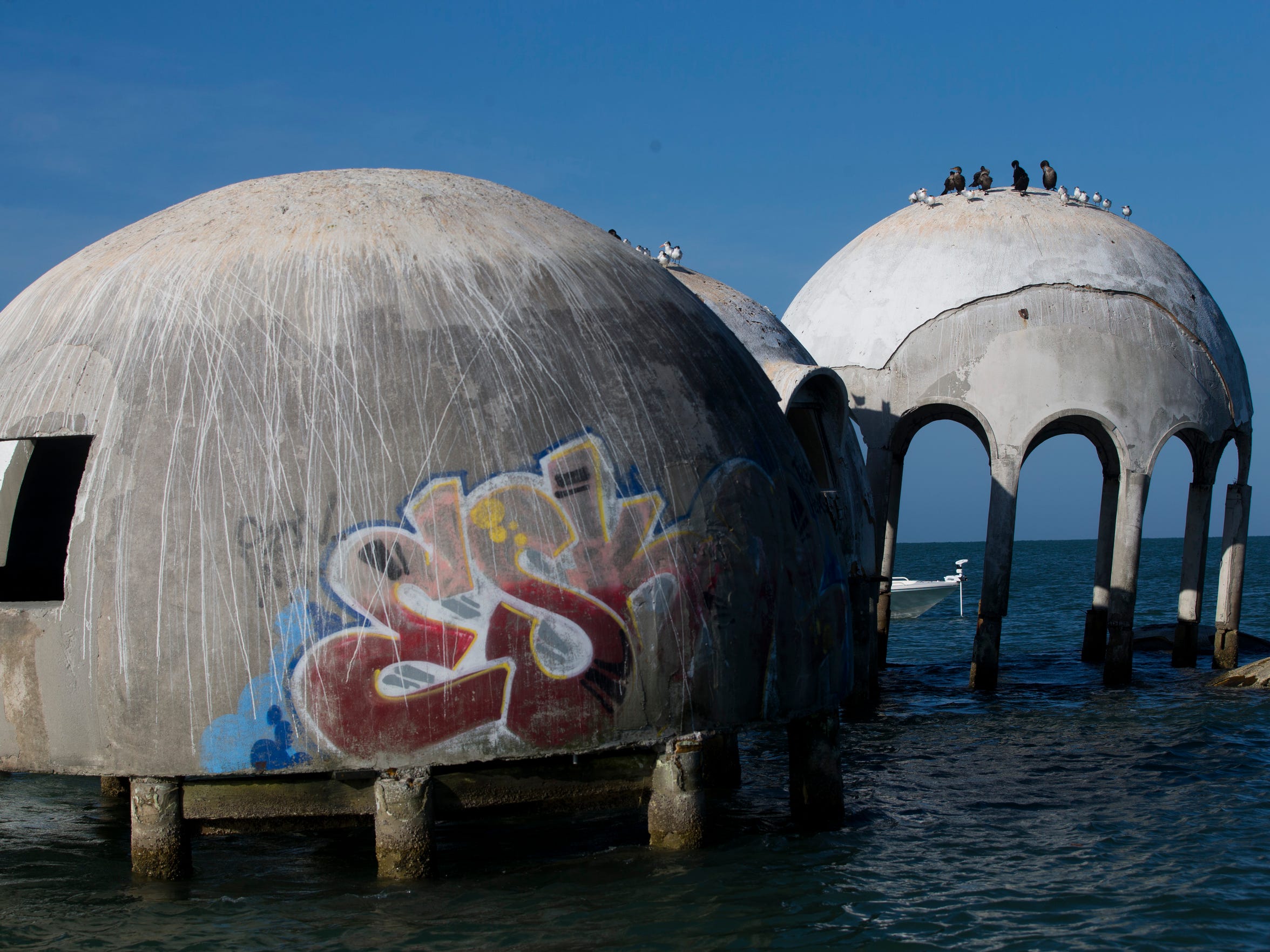 Fate of partly submerged dome home near Marco shifts, now up to state