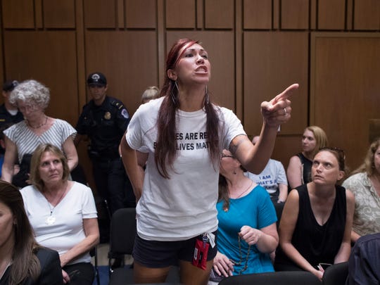 A women's reproductive rights activist protests Judge Brett Kavanaugh's nomination to the U.S. Supreme Court during the Senate Judiciary Committee's confirmation hearing in the Hart Senate Office Building in Washington, D.C., on Sept. 5, 2018.