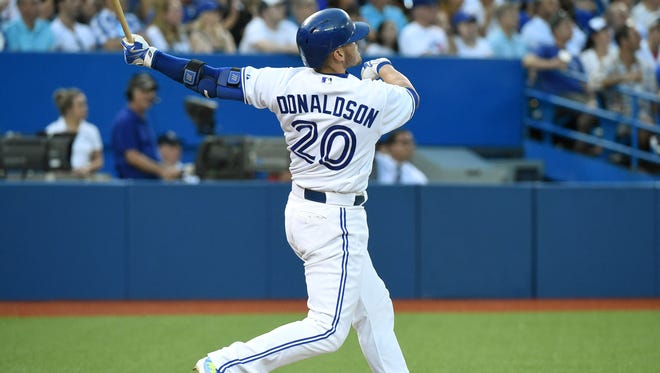 Toronto Blue Jays third baseman Josh Donaldson (20) hits a home run against Kansas City Royals in the fourth inning at Rogers Centre.