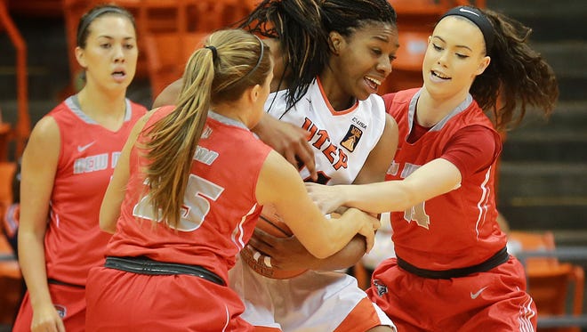 UTEP's Lawna Kennedy, center, fights to keep the ball from New Mexico's Laneah Bryan, left, and Jannon Otto during second quarter action Wednesday.
