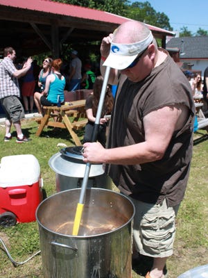 Walt James stirs crawfish boil at the Little Rebel Sunday.