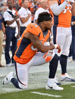 Brandon Marshall kneels for the anthem before the season