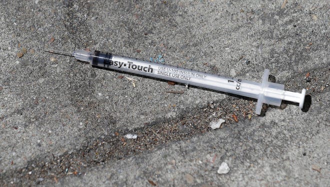 A used syringe is shown on a sidewalk in San Francisco, Thursday, May 10, 2018. The city of San Francisco hands out millions of syringes a year to drug users but has little control over how they are later discarded and that's contributing to dirty streets and hundreds of complaints.