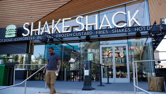In this April 15, 2015, file photo, a man walks out of a Shake Shack in front of the New York-New York hotel and casino in Las Vegas.