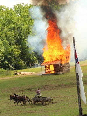 A Confederate wagon driver heads away from a burning building as Yankee troops prepare to top parapets and claim victory during the 2016 Battle of Selma Re-enactment. This year's battle, which was scheduled for April 20-23, was canceled Feb. 1 after organizers received a letter from the city requesting more than $22,000 for "in-kind" services, The Selma Times Journal reported.