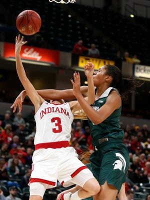 Indiana's Tyra Buss is fouled by Michigan State's Sidney Cooks Thursday night.