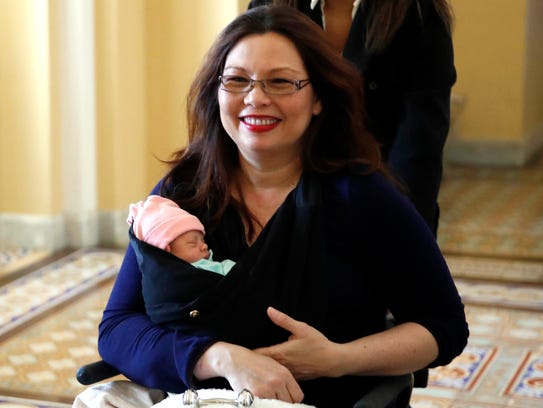 Sen. Tammy Duckworth, D-Ill., carries her baby, Maile