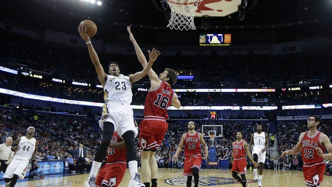 New Orleans Pelicans forward Anthony Davis (23) goes to the basket against Chicago Bulls forward Pau Gasol (16) in the first half of an NBA basketball game in New Orleans, Saturday, Feb. 7, 2015. (AP Photo/Gerald Herbert)