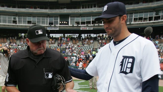 Detroit Tigers pitcher Armando Galarraga, right, puts his hand on the back of tearful umpire Jim Joyce before a game at Comerica Park in Detroit on June 4, 2010.