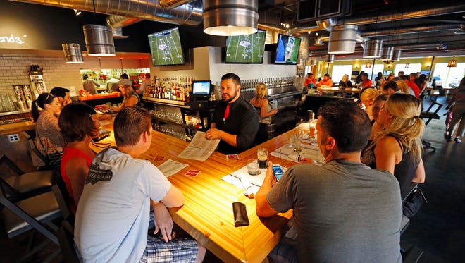 Bartender Nick Westby helps customers  at the Union Barrelhouse in Scottsdale. The area is south of Indian School, north of Goldwater, and west of Scottsdale Road nicknamed "SoDo," for south downtown is on the upswing and  is welcoming new businesses including Union Barrelhouse, which replaced Salty Senorita, and Sip Coffee and Beer.