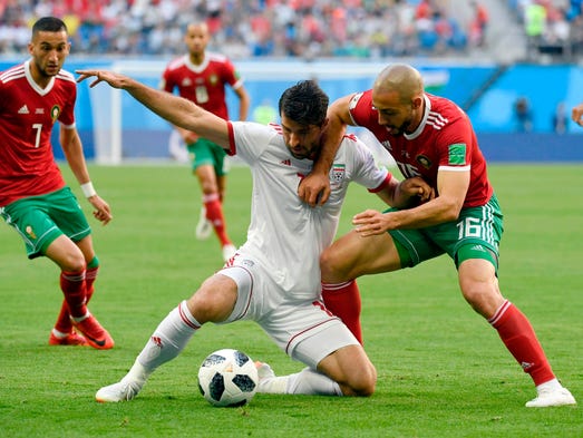 Iran forward Karim Ansari Fard challenges Morocco's