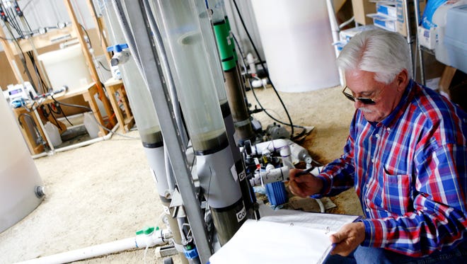 Ron Ruiz, then-superintendent of City of San Angelo Water Quality, writes down the readings of pressure and flow from the columns of water being filtered from a Hickory Aquifer pilot project in 2010.