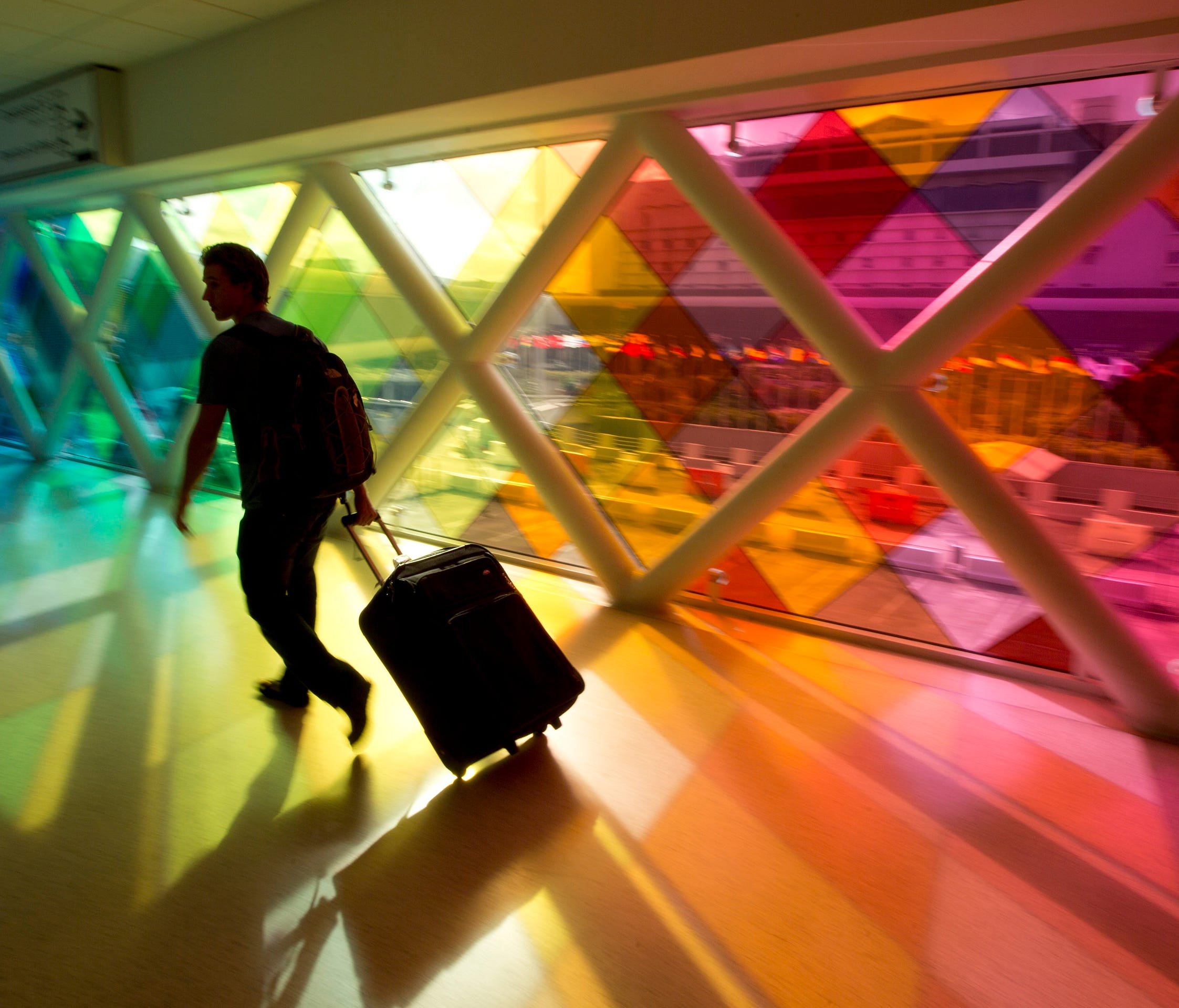 A traveler walks through Miami International Airport.