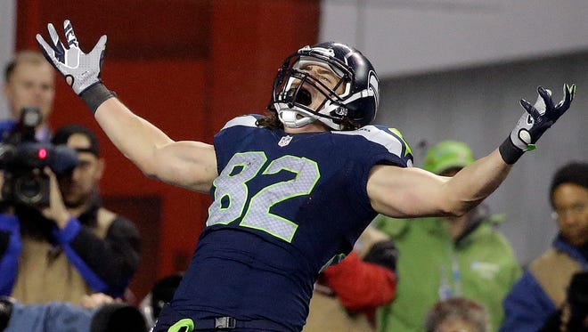 Seattle Seahawks tight end Luke Willson (82) celebrates after catching a 25-yard touchdown pass against the Carolina Panthers during the second half of an NFL divisional playoff football game in Seattle, Saturday, Jan. 10, 2015.