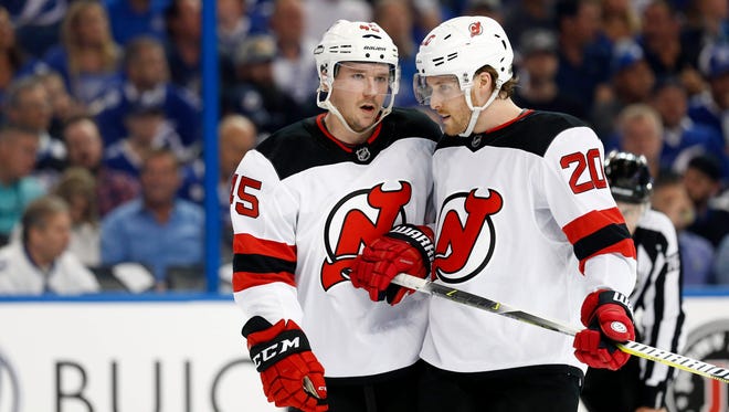New Jersey Devils defenseman Sami Vatanen (45) and New Jersey Devils center Blake Coleman (20) talk during the first period of game one of the first round of the 2018 Stanley Cup Playoffs against the Tampa Bay Lightning at Amalie Arena.