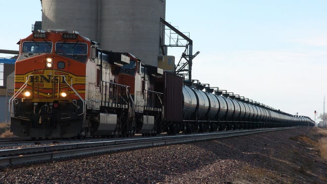 As mile-long oil trains have become common across the United States and Canada, government officials at all levels have raised concerns about the volatility of the Bakken crude oil they carry and the safety of the tank cars. In this file photo, a BNSF Railway train hauls crude oil west of Wolf Point, Montana.