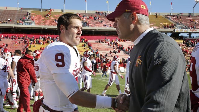 Head coach Paul Rhoads of the Iowa State Cyclones shakes hands with quarterback Trevor Knight #9 of the Oklahoma Sooners at mide field after the Sooners defeated the Cyclones 59-14 at Jack Trice Stadium on November 1, 2014 in Ames, Iowa. The Oklahoma Sooners defeated the Iowa State Cyclones 59-14.