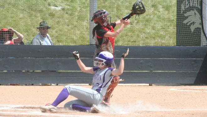 Yerington’s Brooke Menesini slides across the plate ahead of the throw home to score a run during the Lions game against Lincoln County at the Division III State Tournament on May 23.