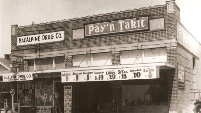 The MacAlpine Drug Co. and Pay'n Takit grocer circa 1938.
