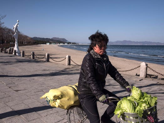 In a photo taken on Nov. 18, 2017, a woman carrying