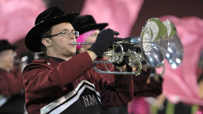 The NMSU Pride Band performs during the halftime show at the 2015 Tough Enough to Wear Pink homecoming football game at Aggie Memorial Stadium.