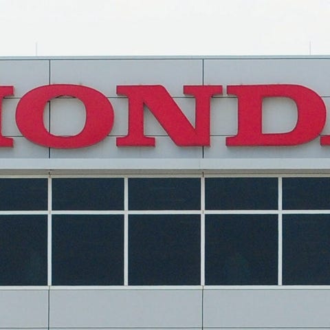A Honda sign on the outside of a factory