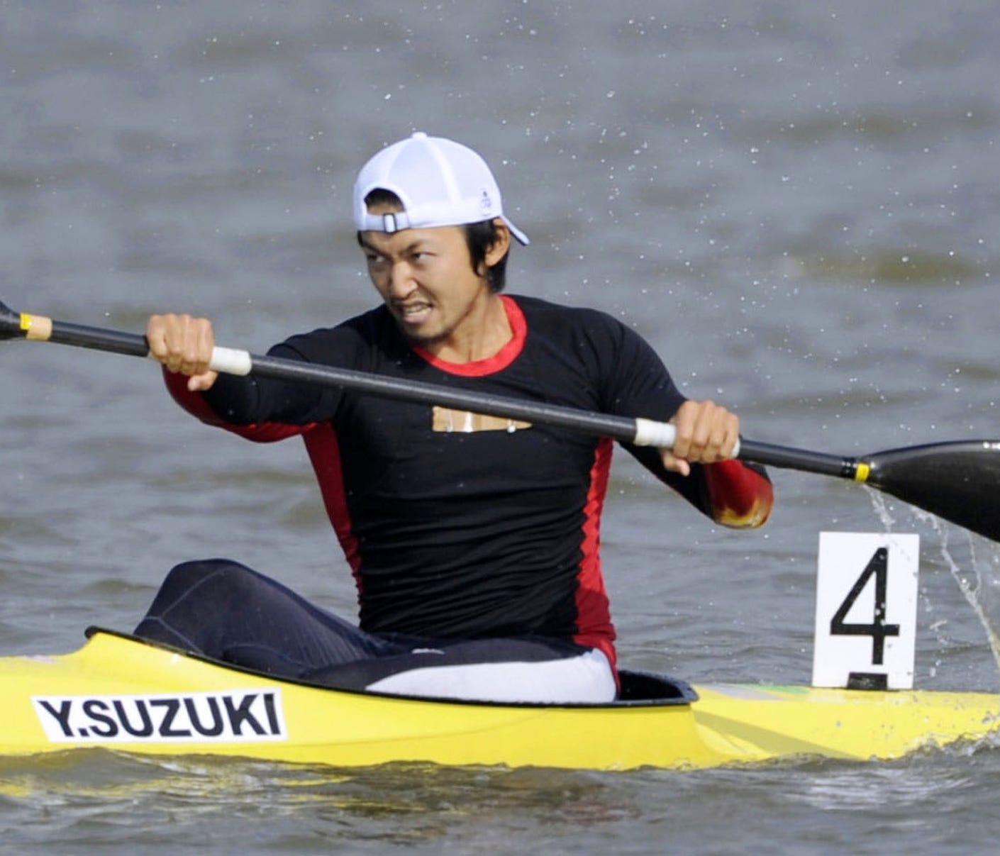 In this November 2010, photo, Japan's Yasuhiro Suzuki competes in the mens single kayak race at the 16th Asian Games in Shanwei, China. The top Japanese canoe sprinter has been banned for eight years, disqualifying him from the Tokyo Olympics, for la