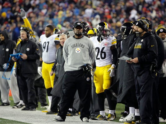 Pittsburgh Steelers head coach Mike Tomlin watches on the sideline beside Pittsburgh Steelers running back Le'Veon Bell (26) during the first half of the AFC championship NFL football game against the New England Patriots, Sunday, Jan. 22, 2017, in Foxborough, Mass. (AP Photo/Steven Senne)