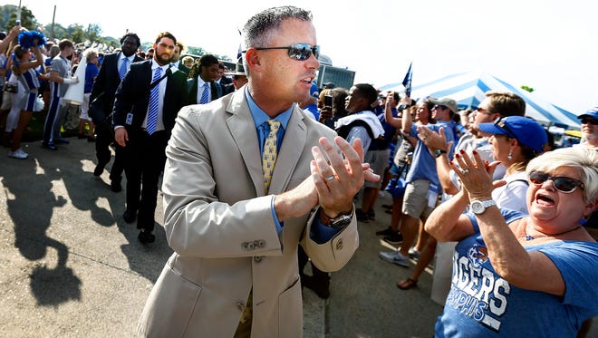 Memphis head coach Mike Norvell cheers with fans during Tiger Walk before a 2017 game against Southern Illinois University.